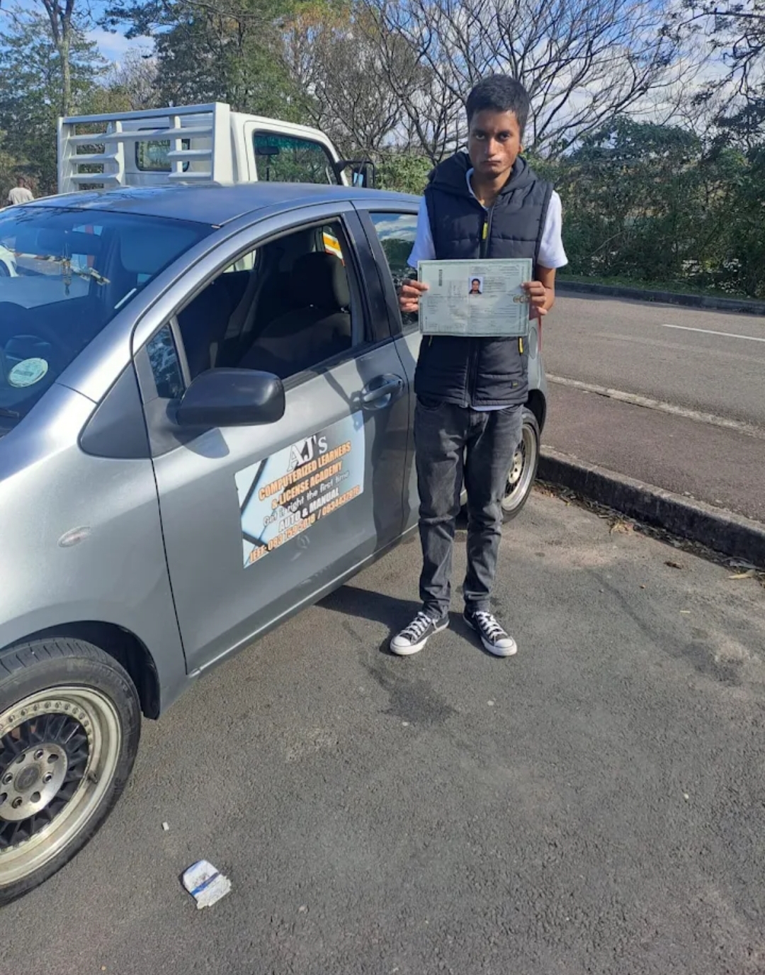 Young driver showing his new licence