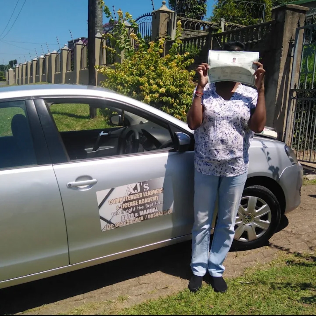 Learner proudly showing her licence document